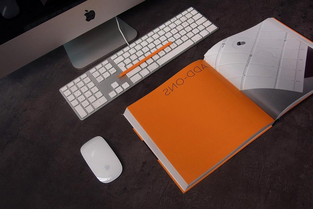Stack of productivity books and digital tools on desk